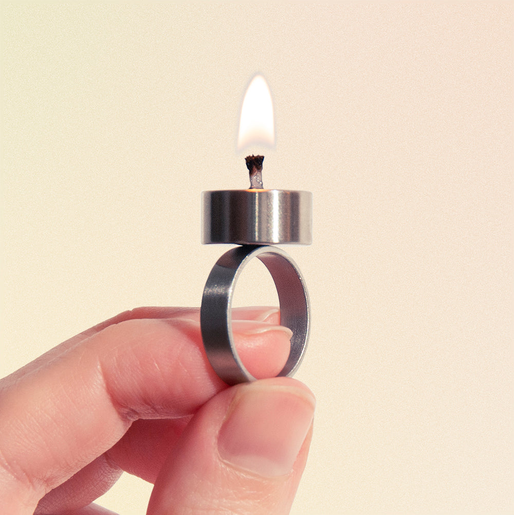 metal jewellery ring with tiny real candle on it