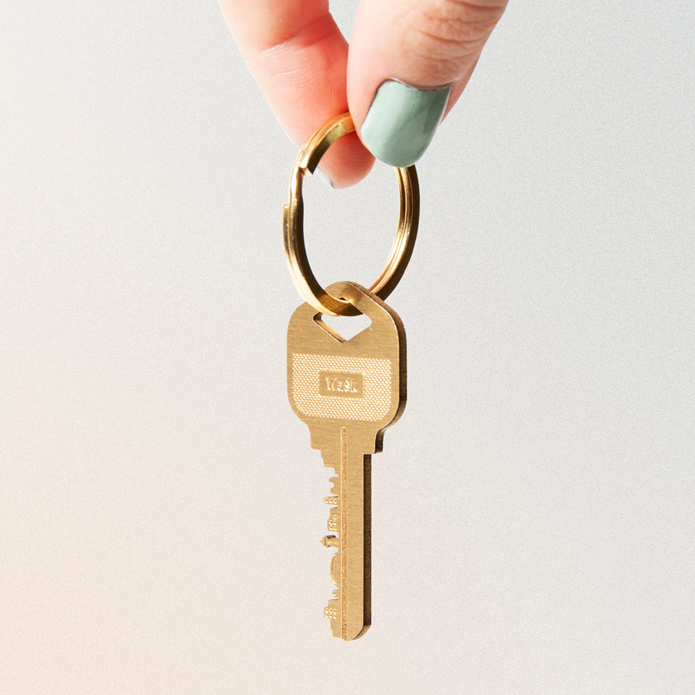 brass key keychain with hidden city on the blade