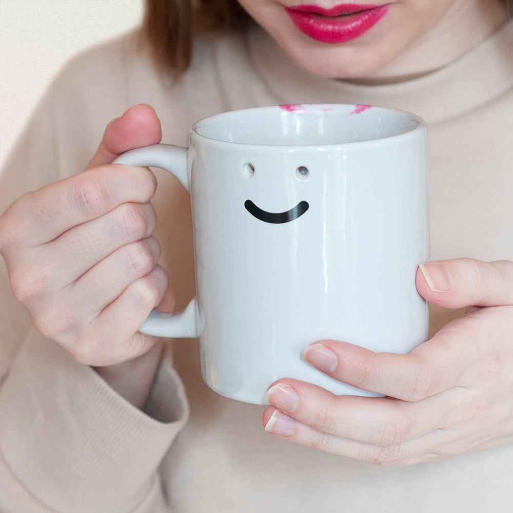 smiley mug with two holes for eyes
