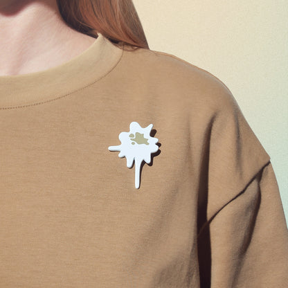 bird poop lapel pin on t-shirt