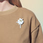 bird poop lapel pin on t-shirt