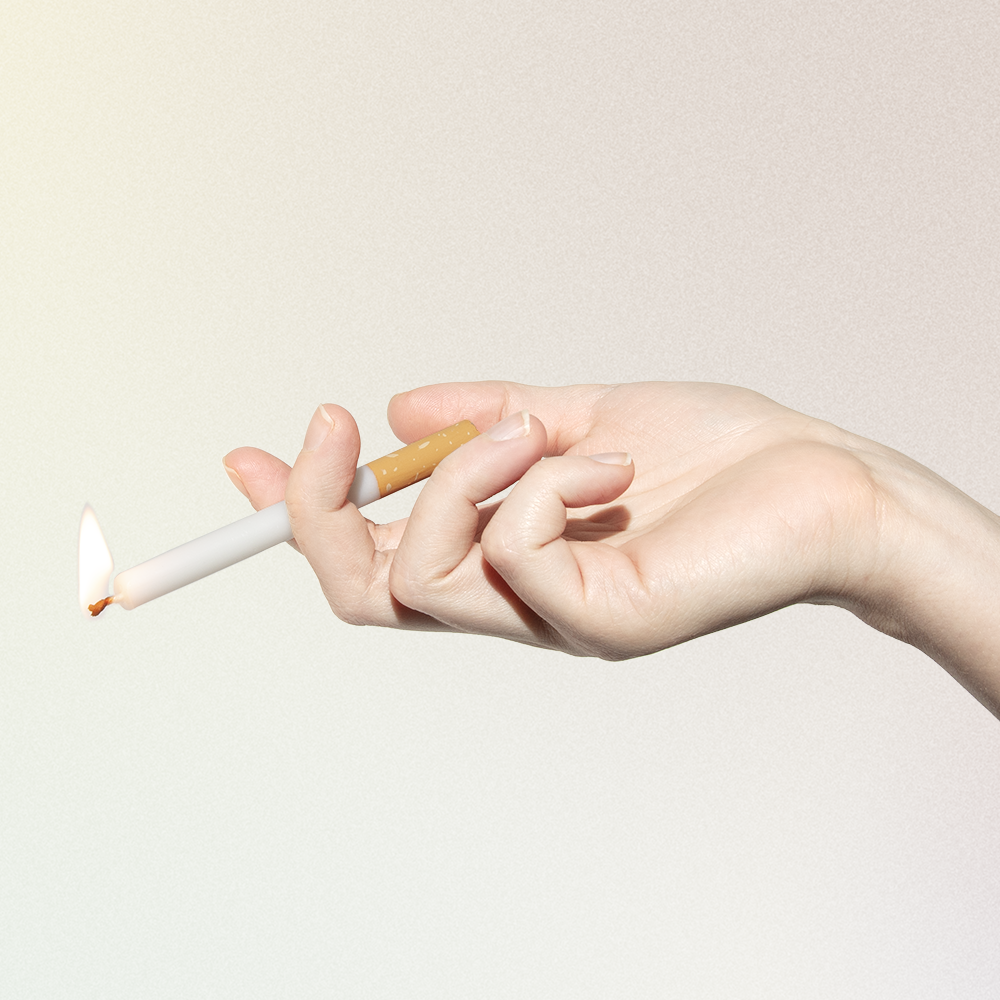 hand holding a candle cigarette